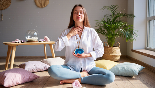 Woman meditating with crystals, channeling energy and communication