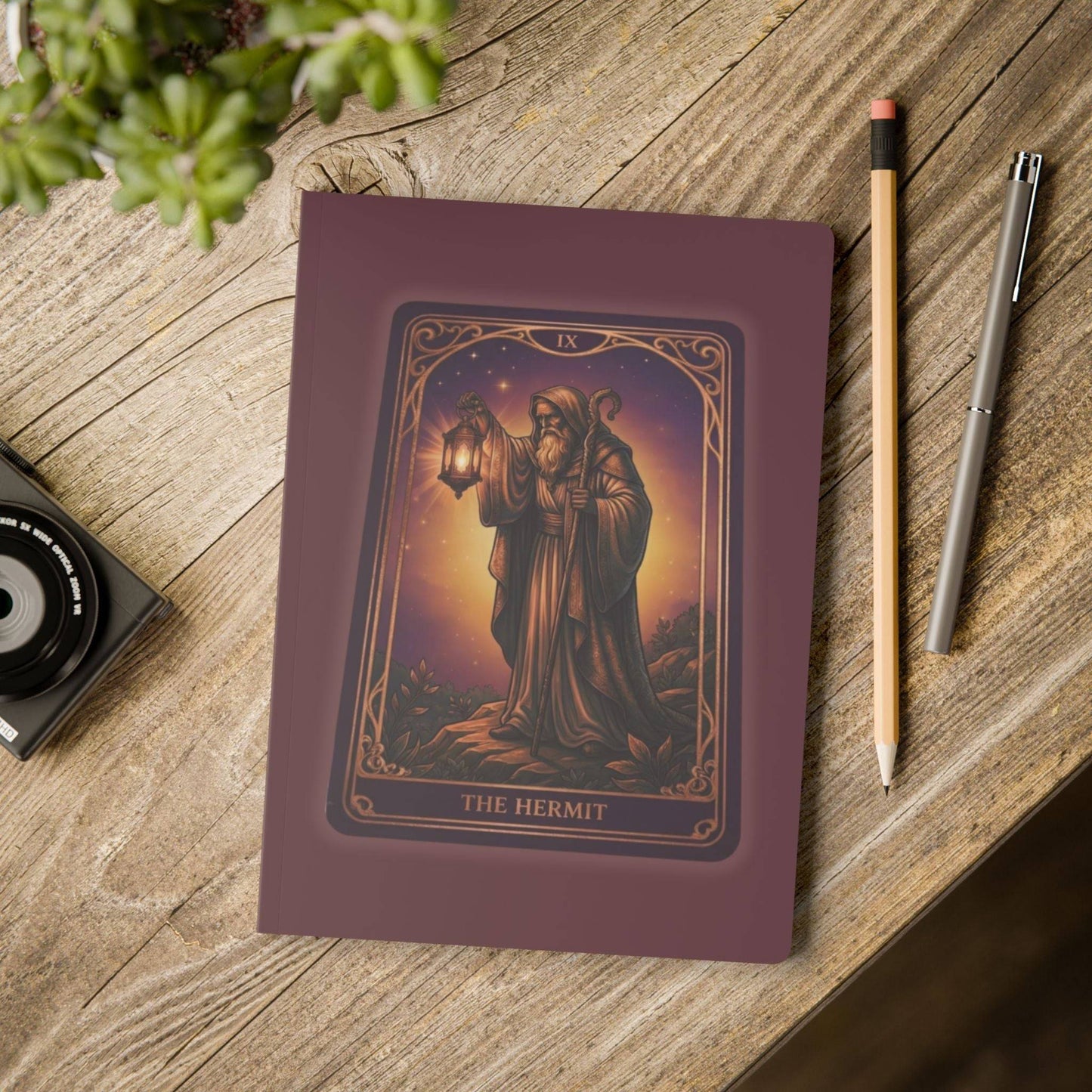 The Hermit Tarot Journal - Soft Cover placed on a wooden desk with pencil and pen, perfect for journaling, note-taking, or tarot reflections.