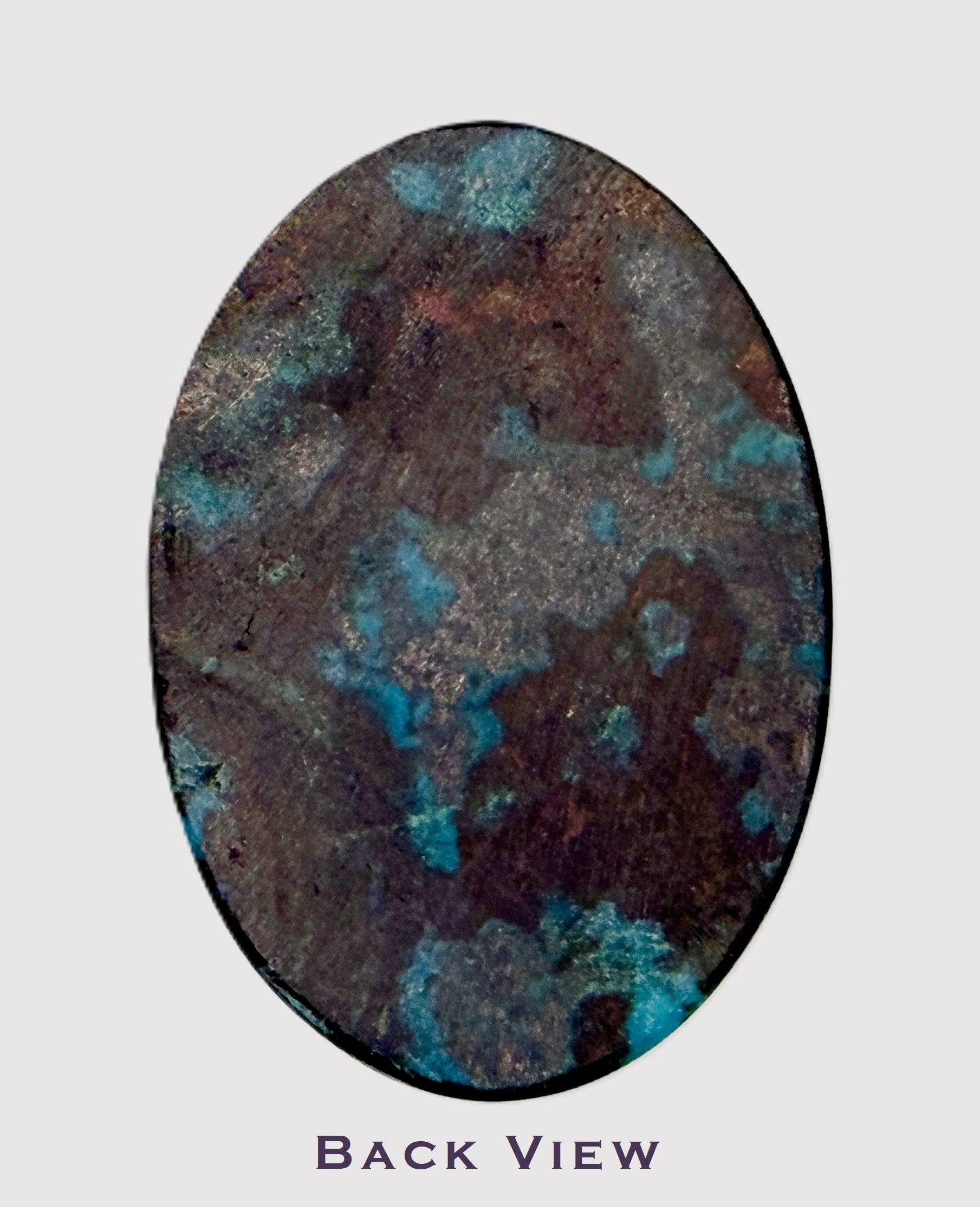 Oval-shaped chrysocolla cabochon with blue and brown patterns on a light gray background