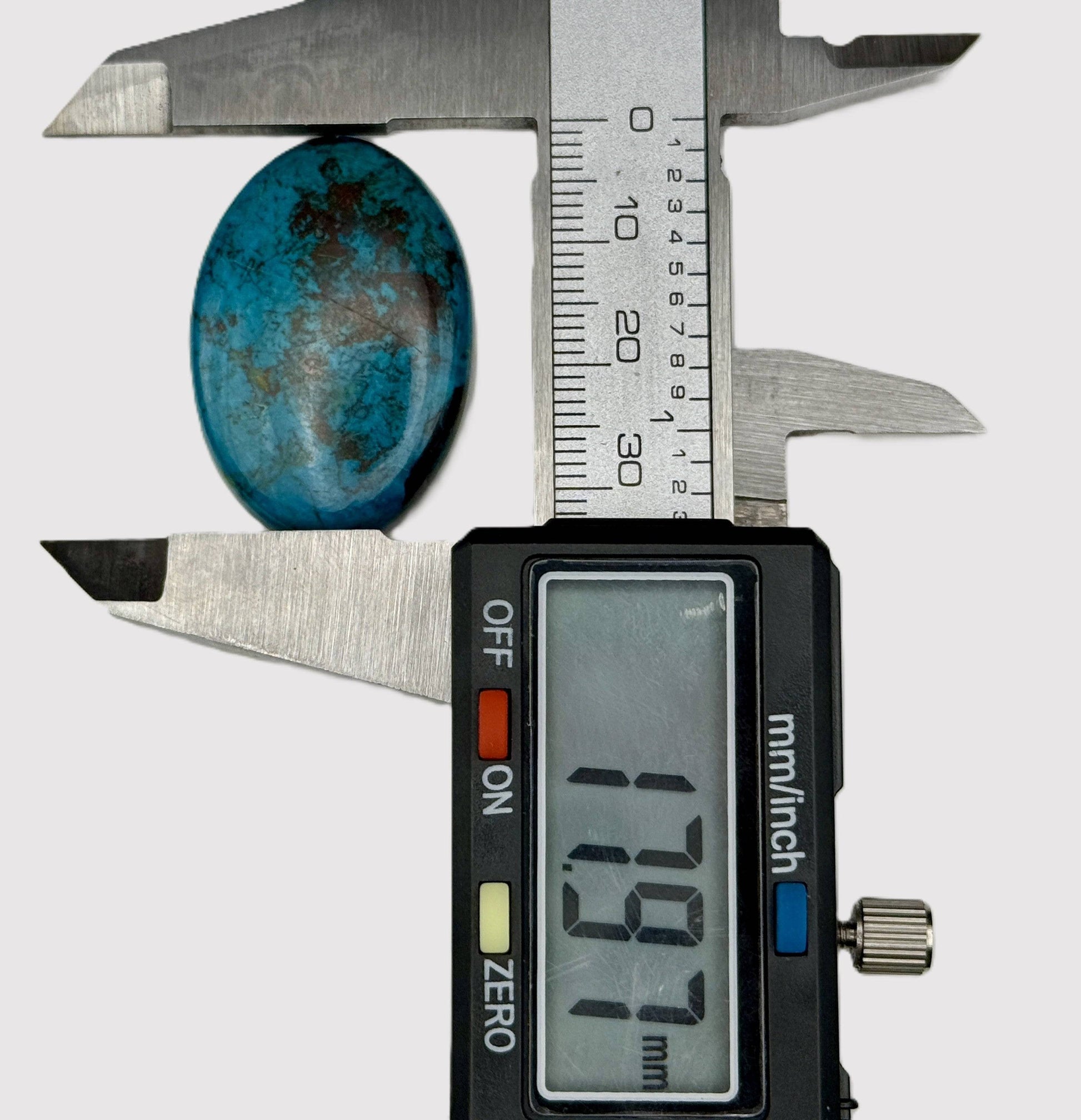 Digital caliper measuring a chrysocolla stone 17.97mm