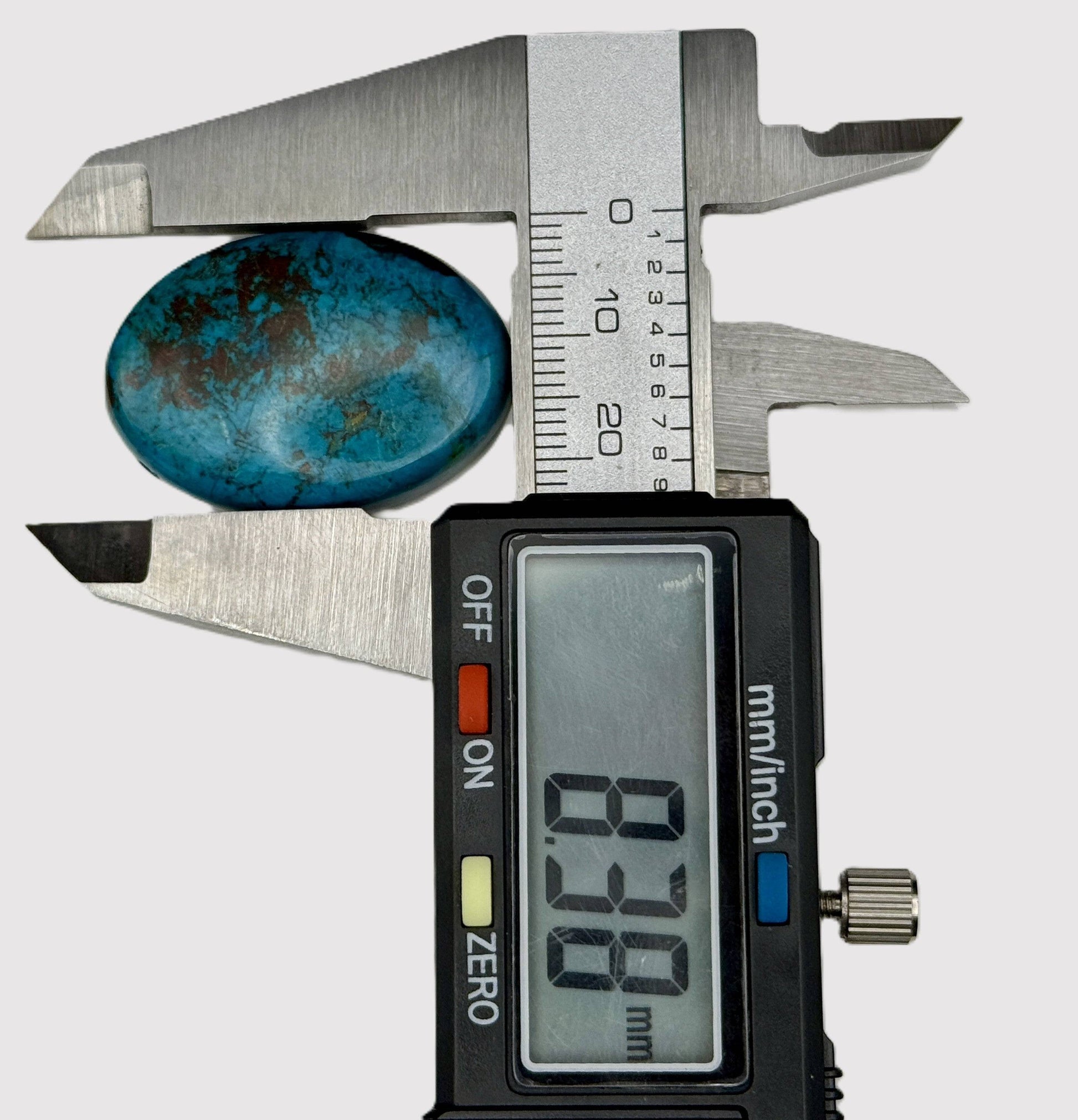 Digital caliper measuring a chrysocolla stone 8.38mm