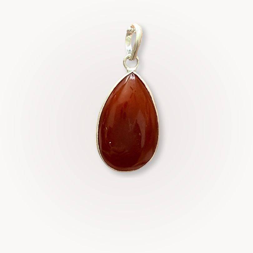 Close-up of Carnelian Classic Pendant featuring polished teardrop gemstone in silver bezel, ideal for grounding and daily wear.