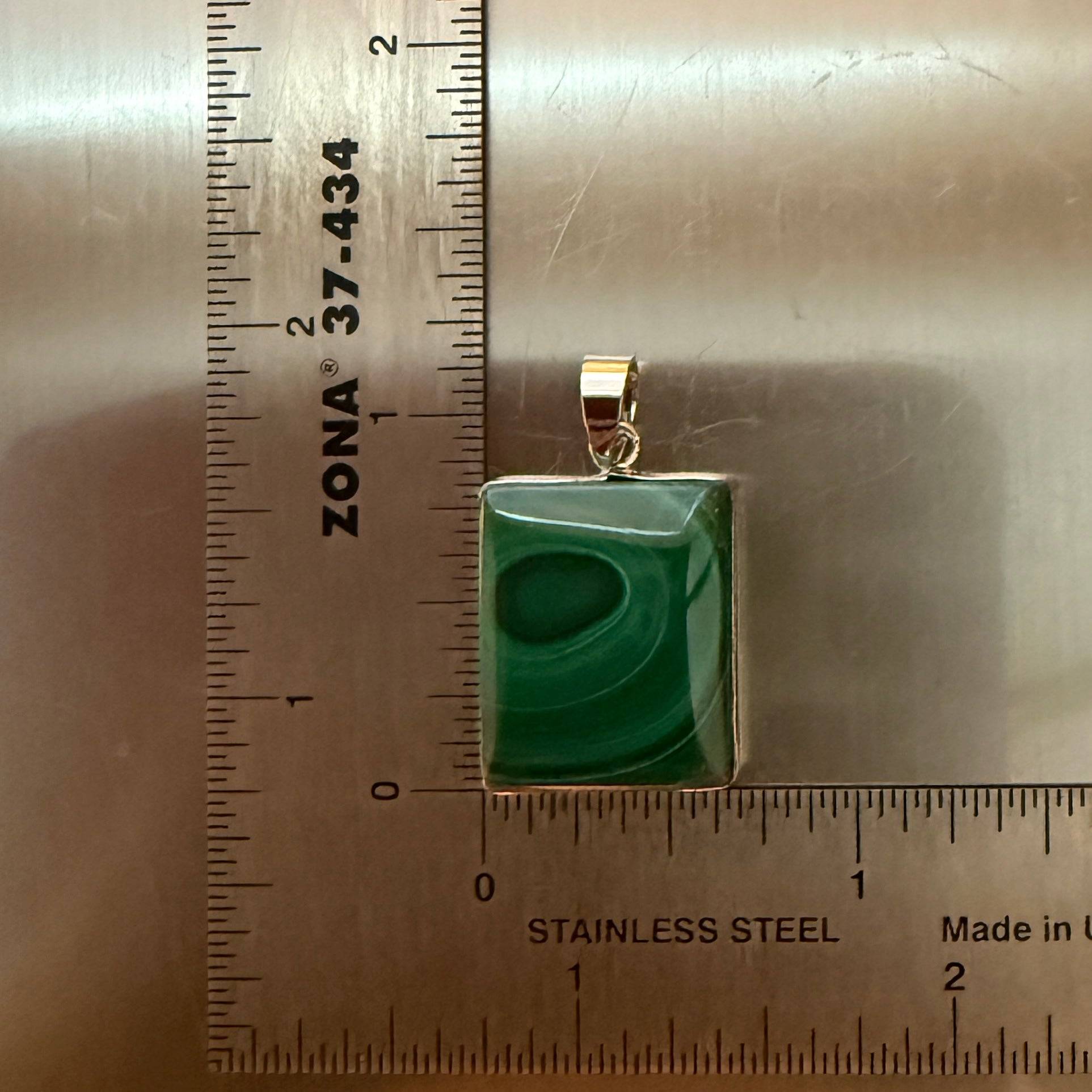 Size Small 40ct - natural malachite  natural malachite pendant with silver bale, high-polish front, placed beside a stainless steel ruler for size reference.