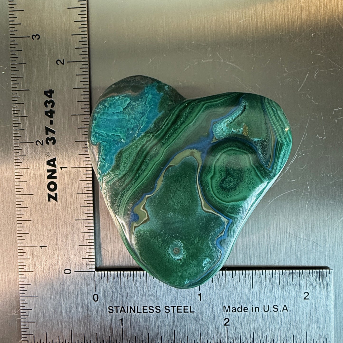 Heart-shaped MalaColla Freeform from Madagascar with vivid malachite and chrysocolla banding, shown with ruler for scale.