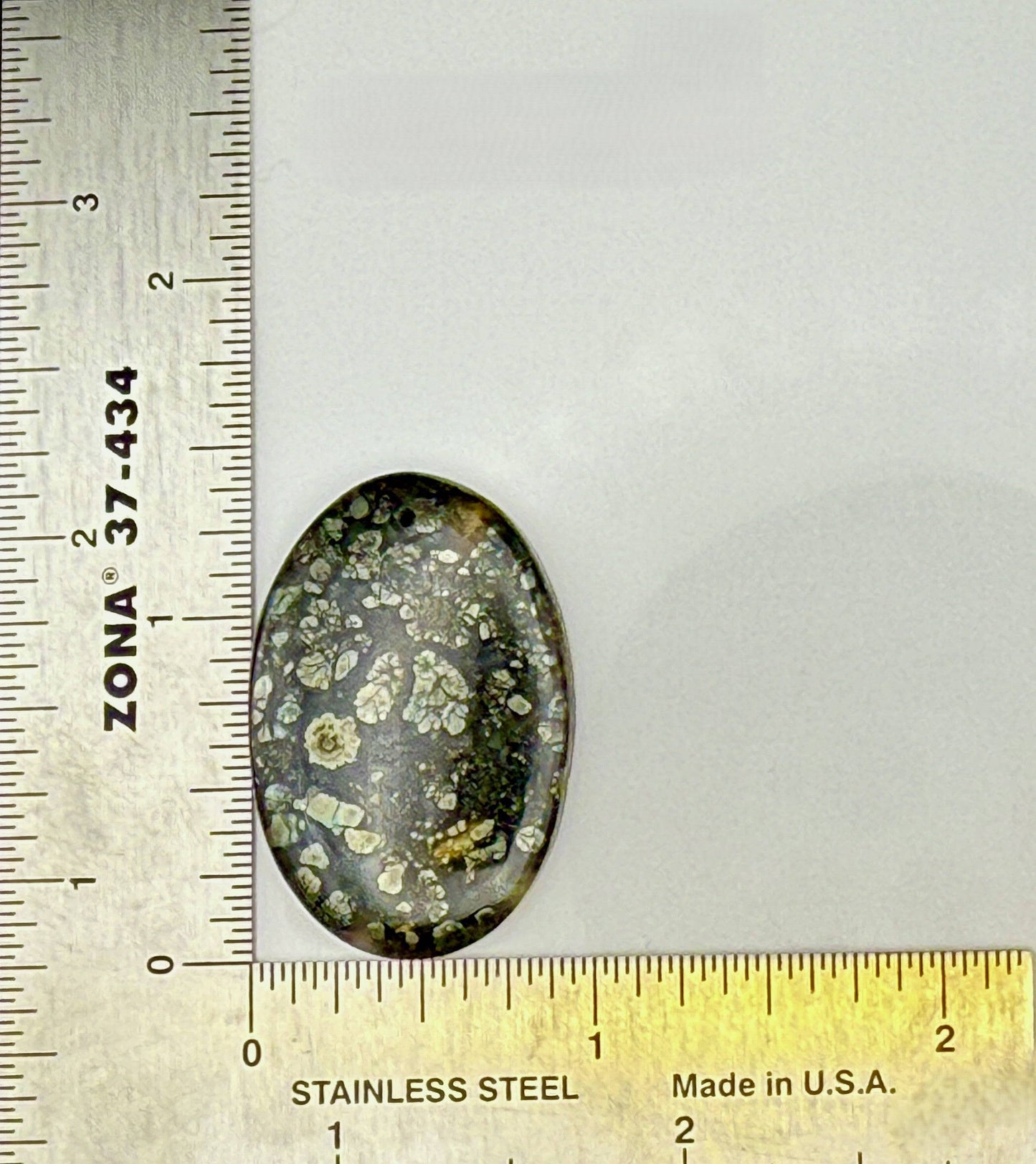 Glossy Marcasite cabochon oval gemstone with golden flashes