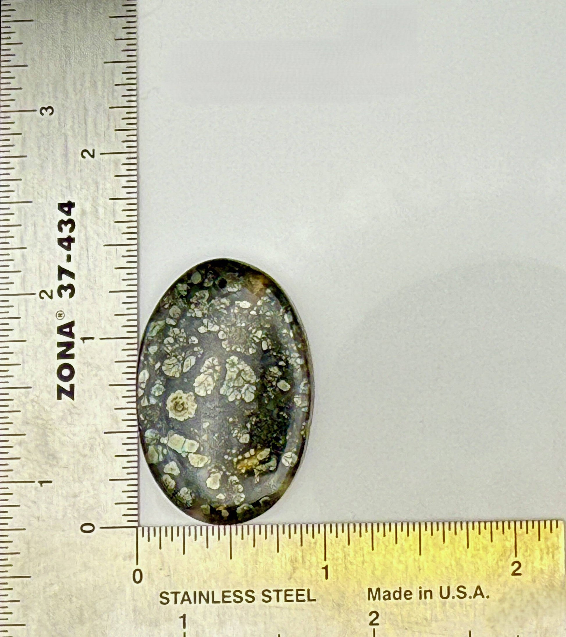 Glossy Marcasite cabochon oval gemstone with golden flashes