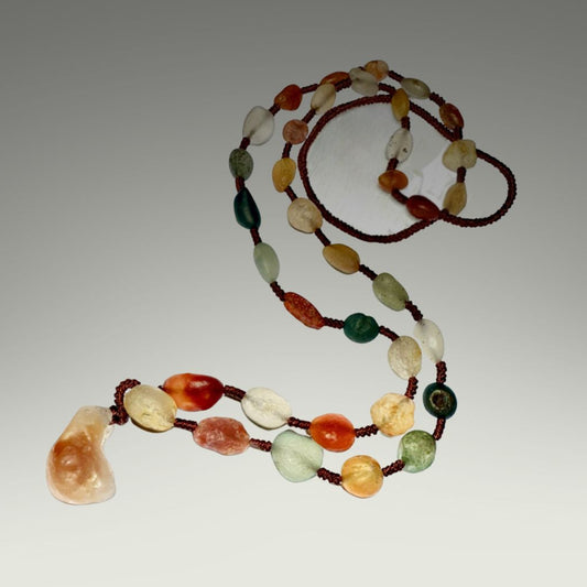 Multicolored beaded necklace on a gray background