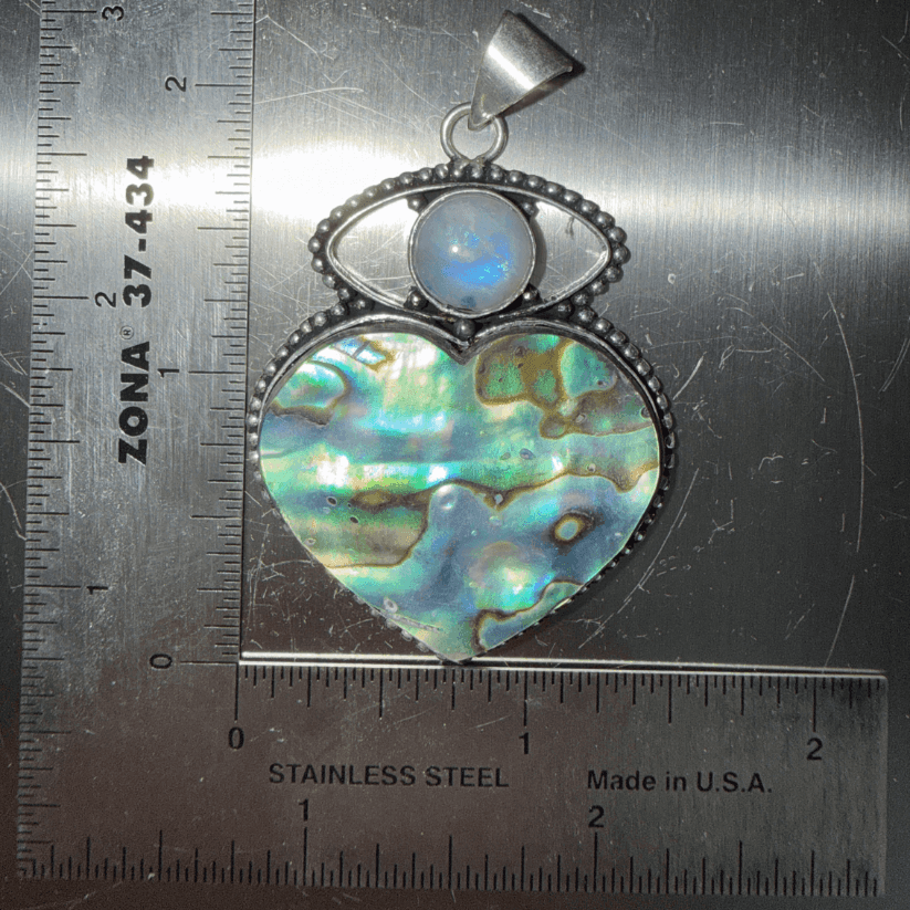 Rainbow Moonstone Evil Eye & Abalone Heart Pendant with sterling silver setting, featuring iridescent abalone shell and protective moonstone cabochon.
