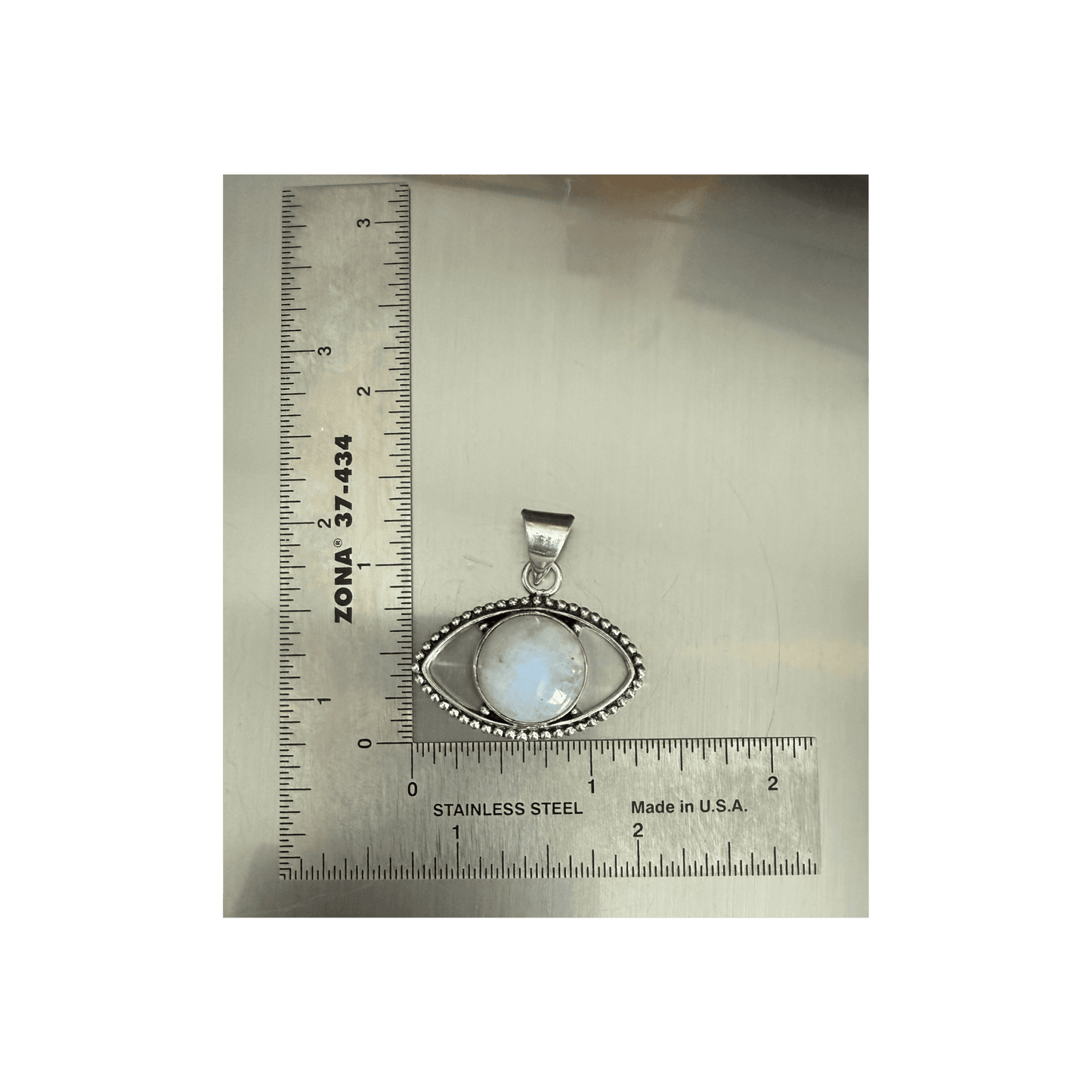 Rainbow Moonstone Evil Eye Pendant in sterling silver with beaded detailing, shown next to ruler for size reference. Enhances intuition and protection.