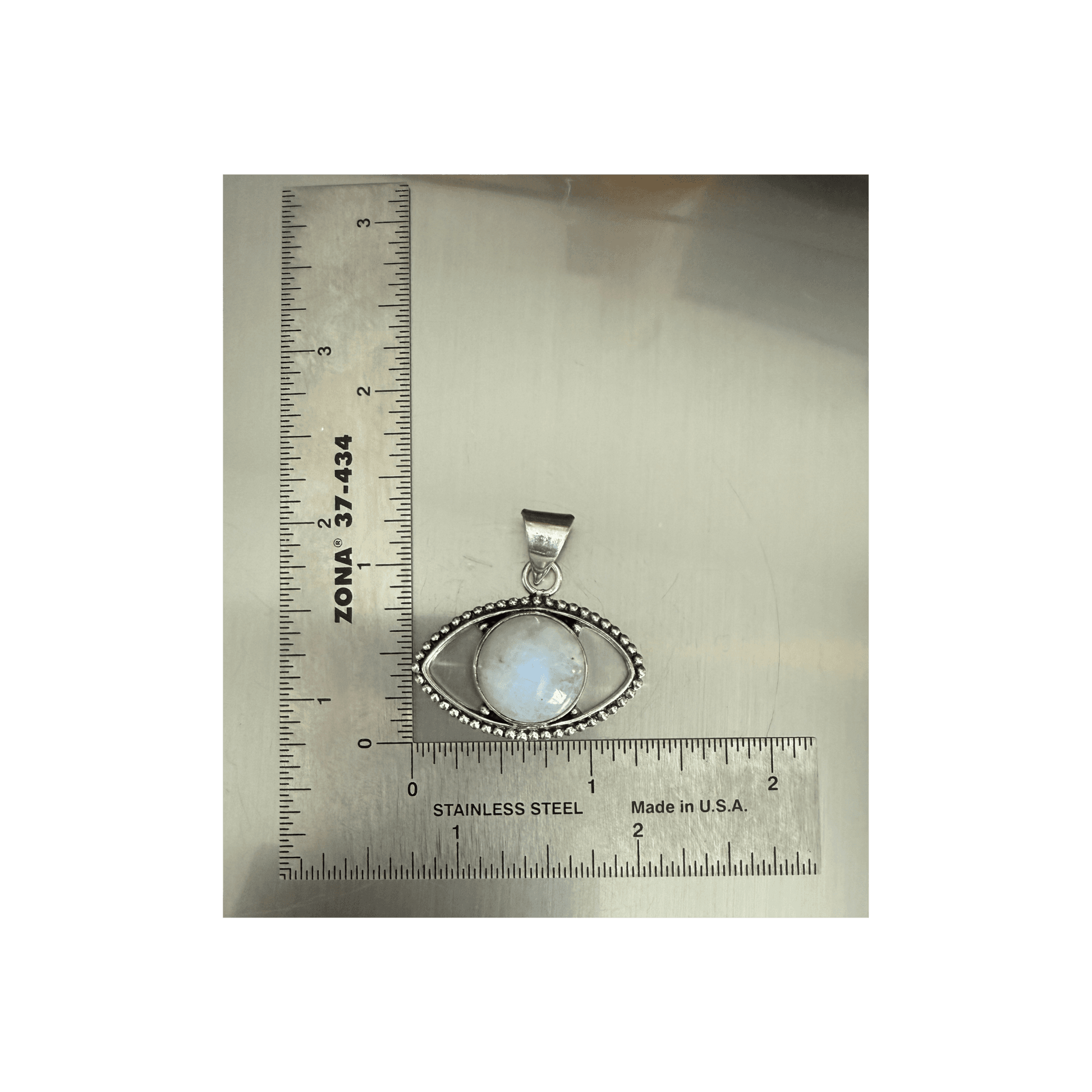 Rainbow Moonstone Evil Eye Pendant in sterling silver with beaded detailing, shown next to ruler for size reference. Enhances intuition and protection.