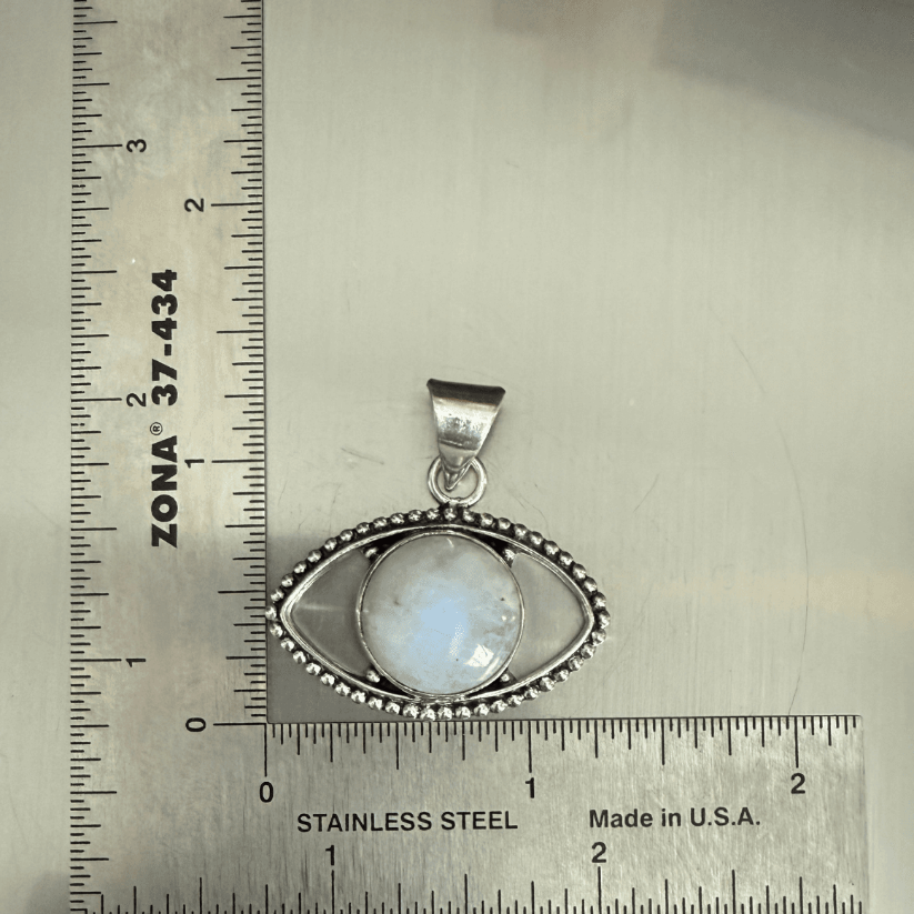 Rainbow Moonstone Evil Eye Pendant in sterling silver with beaded detailing, shown next to ruler for size reference. Enhances intuition and protection.