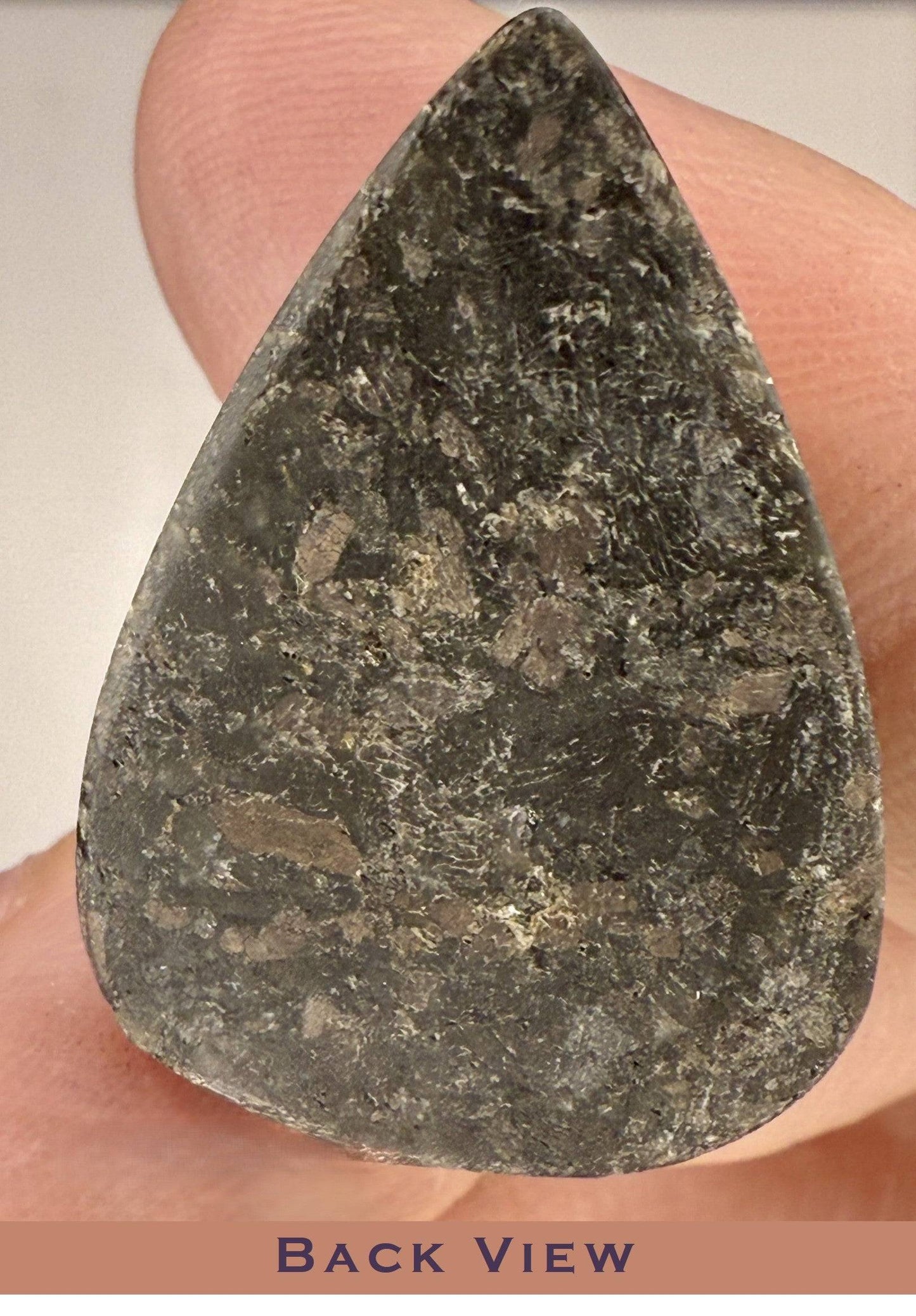 Back view of a Rare Nuummite cabochon gemstone 25 carats