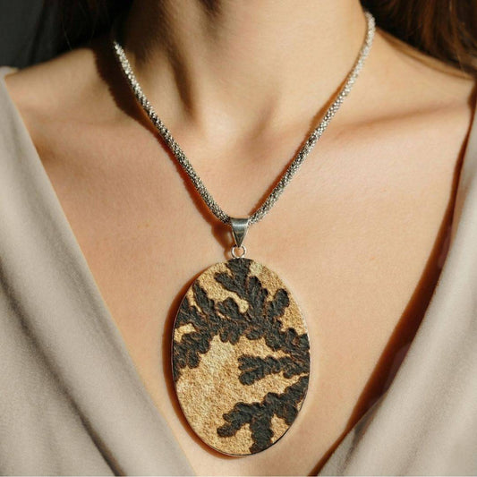 Large Psilomelane Jasper pendant worn on chest, showcasing natural black dendritic patterns. Ideal for grounding and shadow work in jewelry fashion.