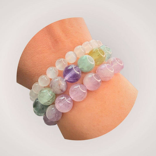 Stacked Rainbow Fluorite 12mm Beaded Bracelet on wrist, showcasing vibrant gemstone colors that promote clarity and intuition in a stylish accessory.