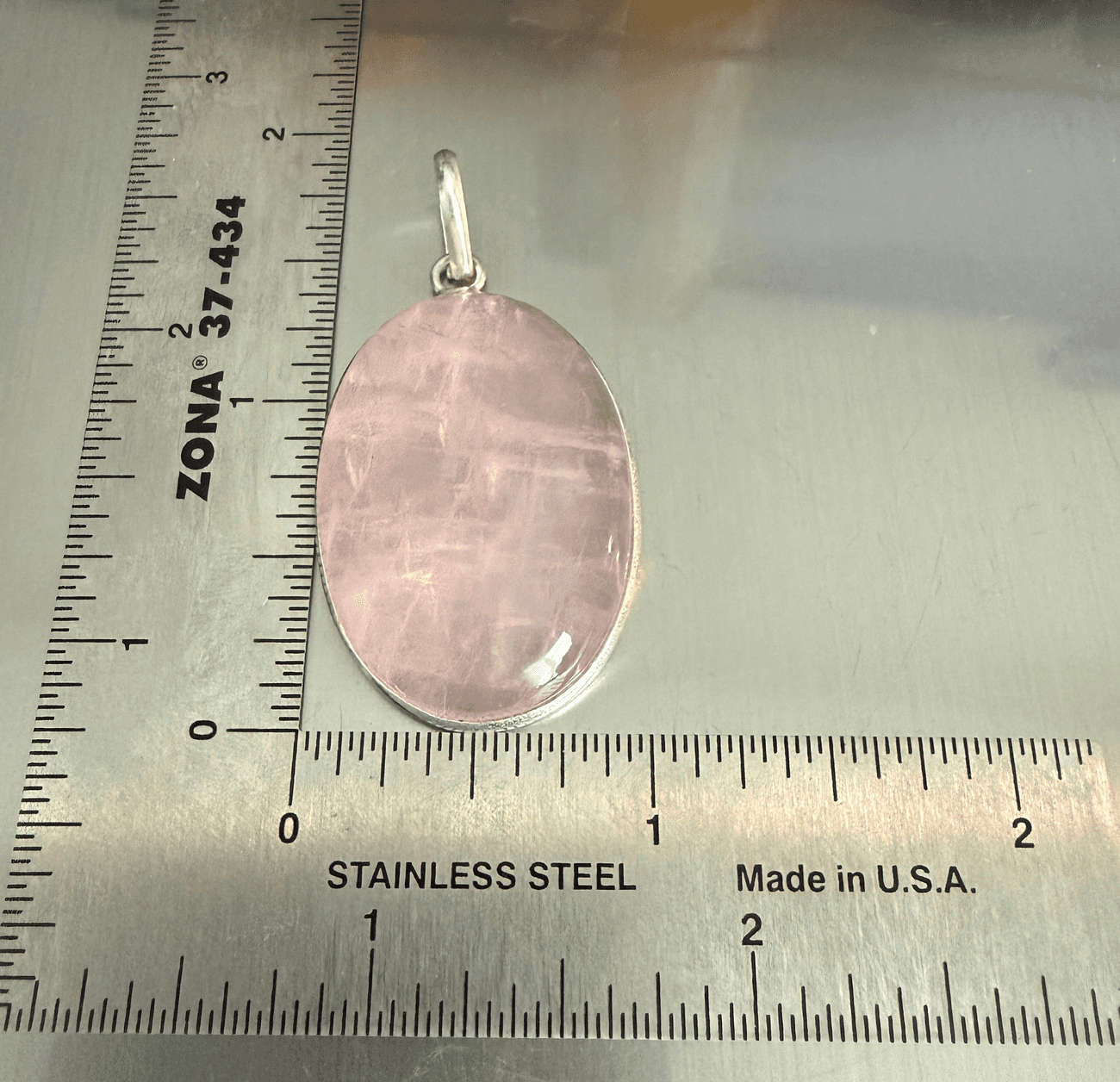 Rose Quartz Oval Pendant - Love & Healing in sterling silver, placed next to a ruler for size reference. Ideal for emotional healing jewelry.