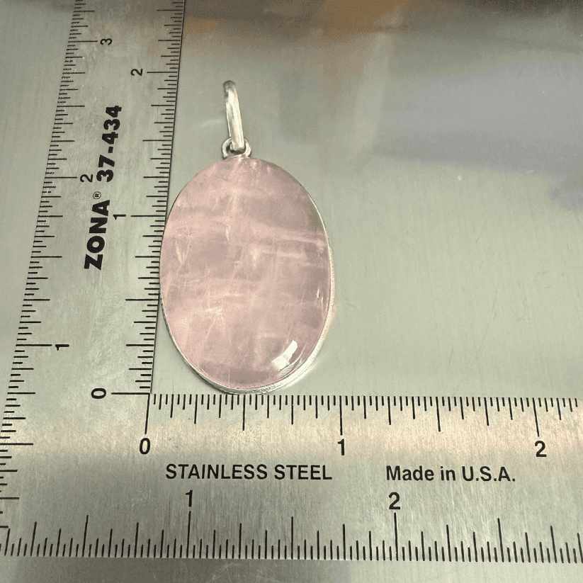 Rose Quartz Oval Pendant - Love & Healing in sterling silver, placed next to a ruler for size reference. Ideal for emotional healing jewelry.