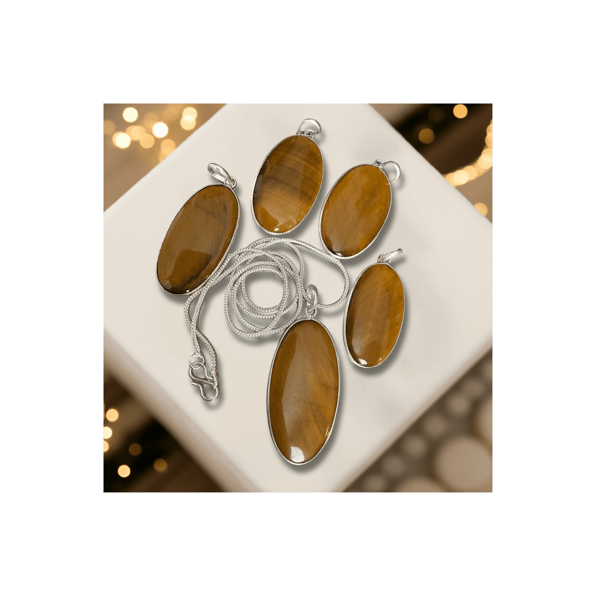 Tigers Eye Oval Pendant in sterling silver with polished brown-gold hues, symbolizing courage, clarity, and protection. Ideal for grounding and focus.