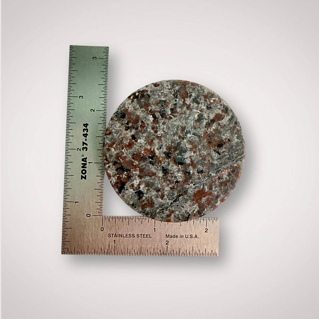66mm round UV Sodalite Charging Plate shown with ruler for scale, perfect for intuitive energy activation and decor.