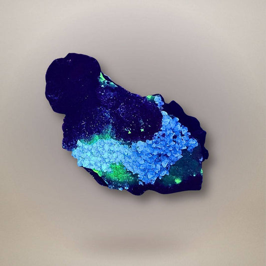Fluorescent adamite with calcite on limonite from Ojuela Mine, Mexico, showing vivid green adamite response under UV light.
