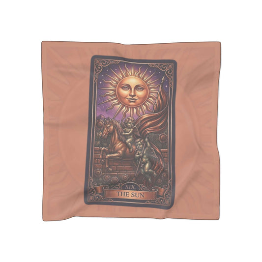 Decorative cloth with 'The Sun' tarot card design on a peach background