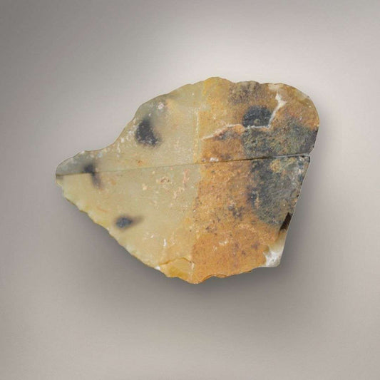 Natural polyhedral agate nodule showing angular flat-sided structure and warm exterior rind