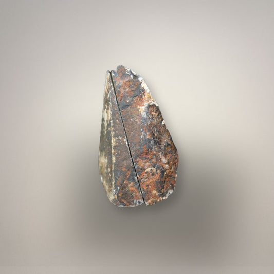 Compact polyhedral agate nodule showing angular flat-sided structure and cavity formation