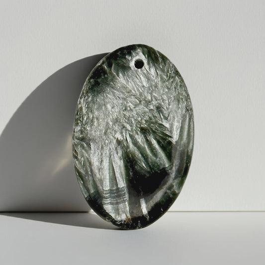 Mystic Parcel view of Seraphinite “Angel Stone” 25ct oval cabochon with silver feather chatoyance
