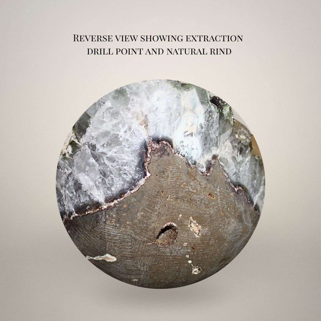Reverse of quartz geode showing drill point from extraction and flat-cut base for display stability