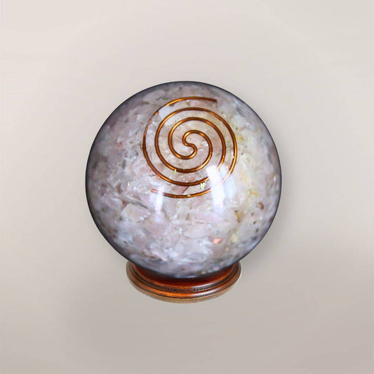 Rose Quartz orgonite sphere with Brazilian Rose Quartz chips, copper spiral, copper flakes, and wood display stand