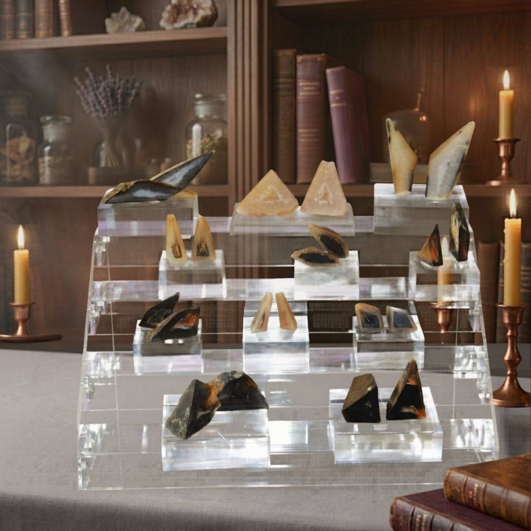 Crystal display with Polyhedral Agate Pairs on a table in a room with candles and books.