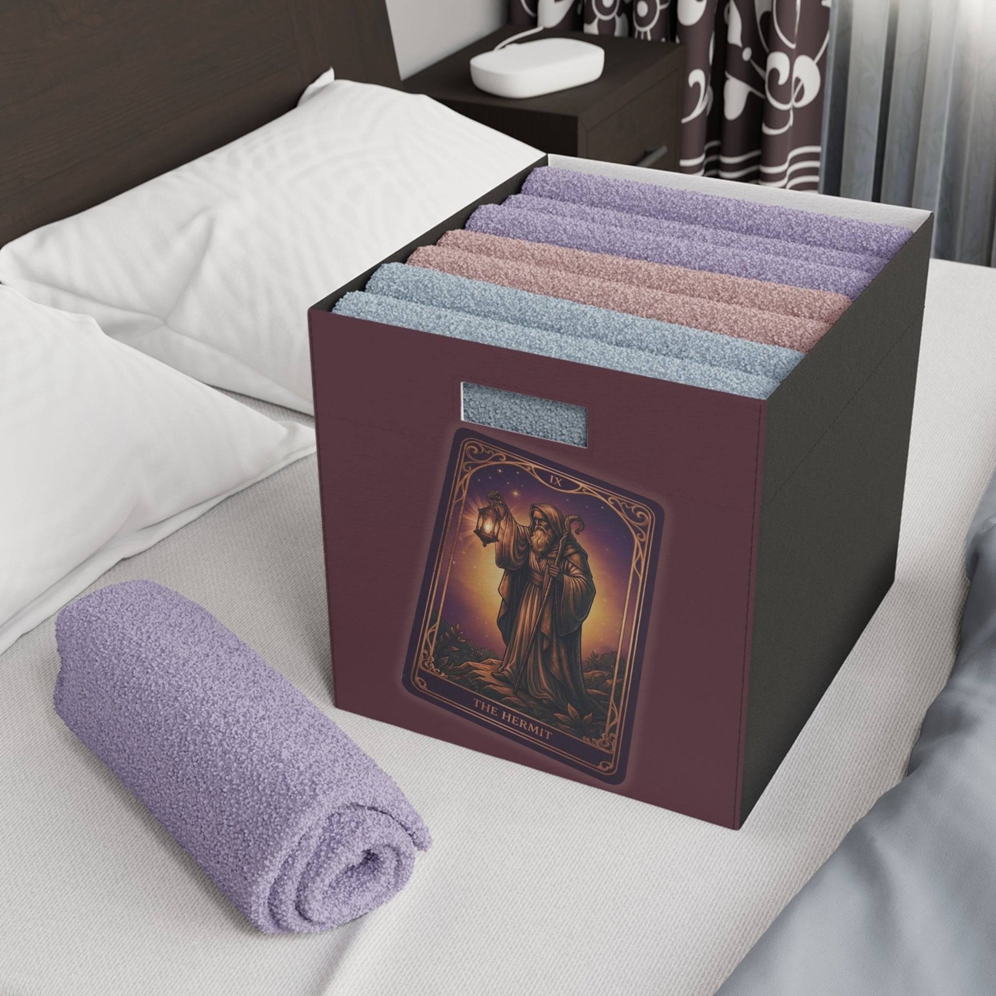 The Hermit Tarot felt storage box used for organizing towels in a bedroom, blending mystic decor with practical storage.