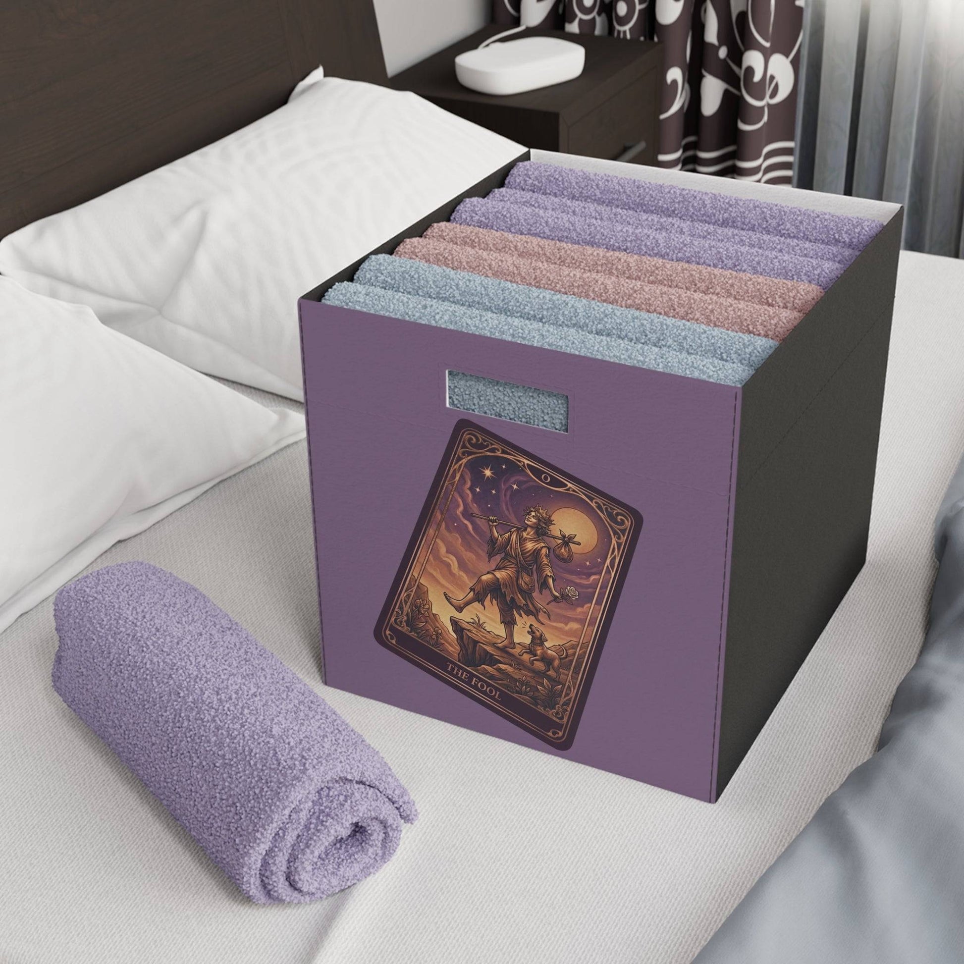 The Fool Tarot Storage Box holding rolled towels on bed