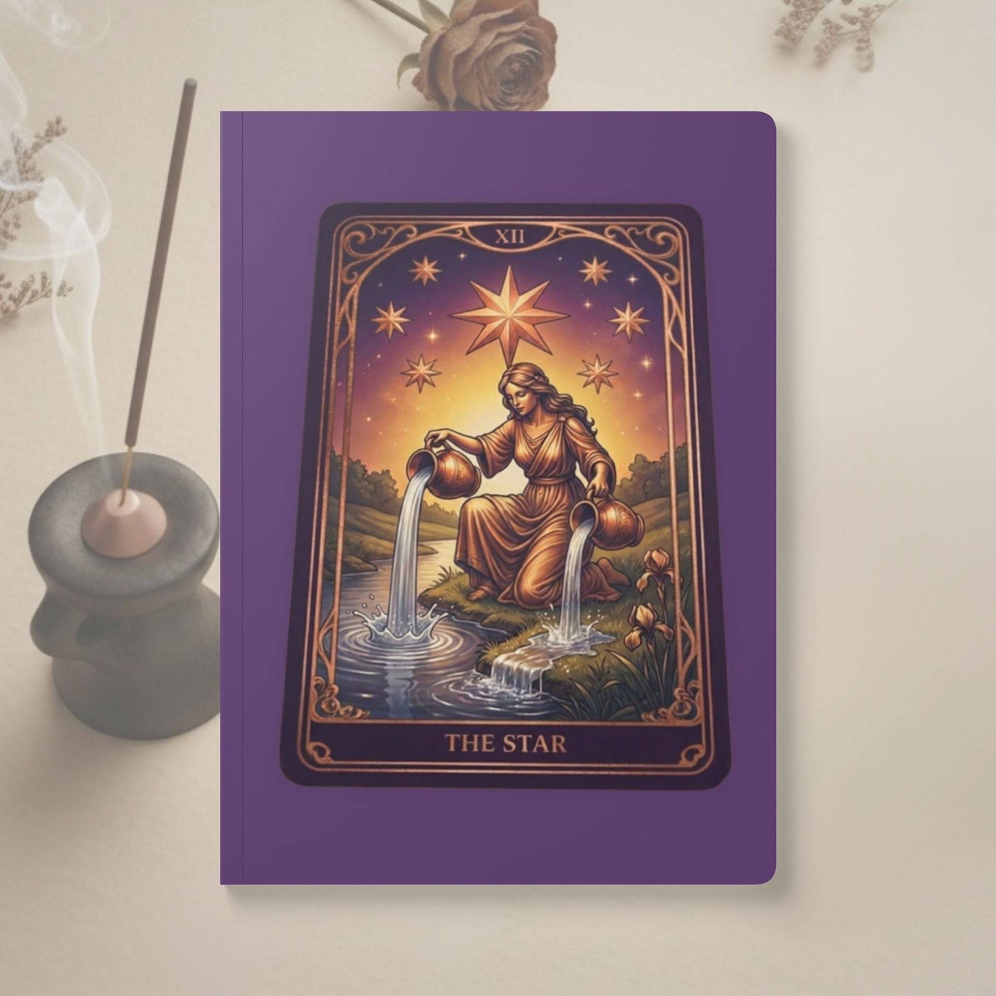 The Star Tarot Softcover Journal by Mystic Parcel features a vibrant tarot card illustration on a purple cover, ideal for journaling or note-taking.