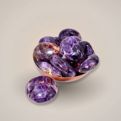 Polished purple gemstone with hematite inclusions, Alien Amethyst palm stone