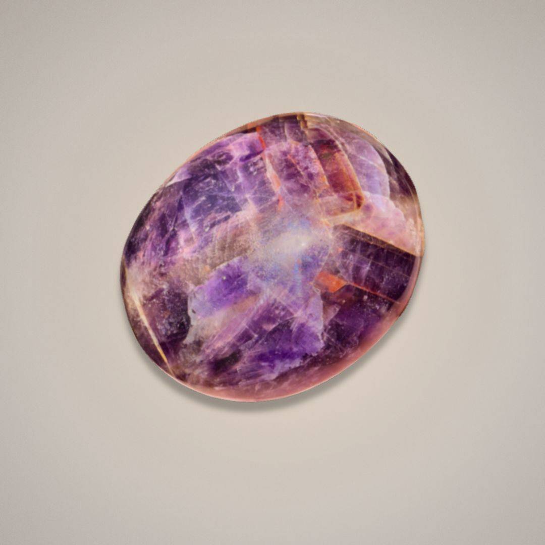 Close-up of polished Alien Amethyst palm stone with purple and orange streaks