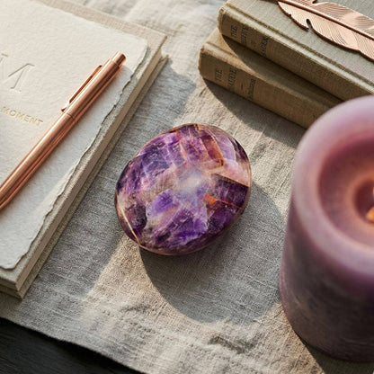 Medium Alien Amethyst palm stone with purple hues and earthy inclusions