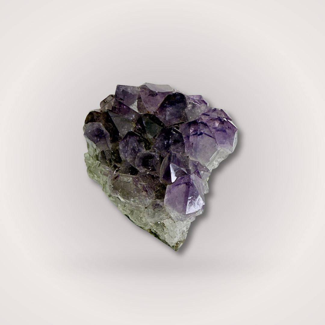 High-grade Brazilian Amethyst Geode Cluster Piece with large pointed crystals, weighing 50–100g, ideal for sacred spaces or gifts.