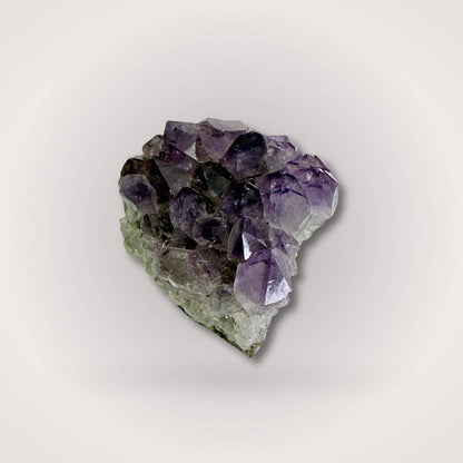High-grade Brazilian Amethyst Geode Cluster Piece with large pointed crystals, weighing 50–100g, ideal for sacred spaces or gifts.