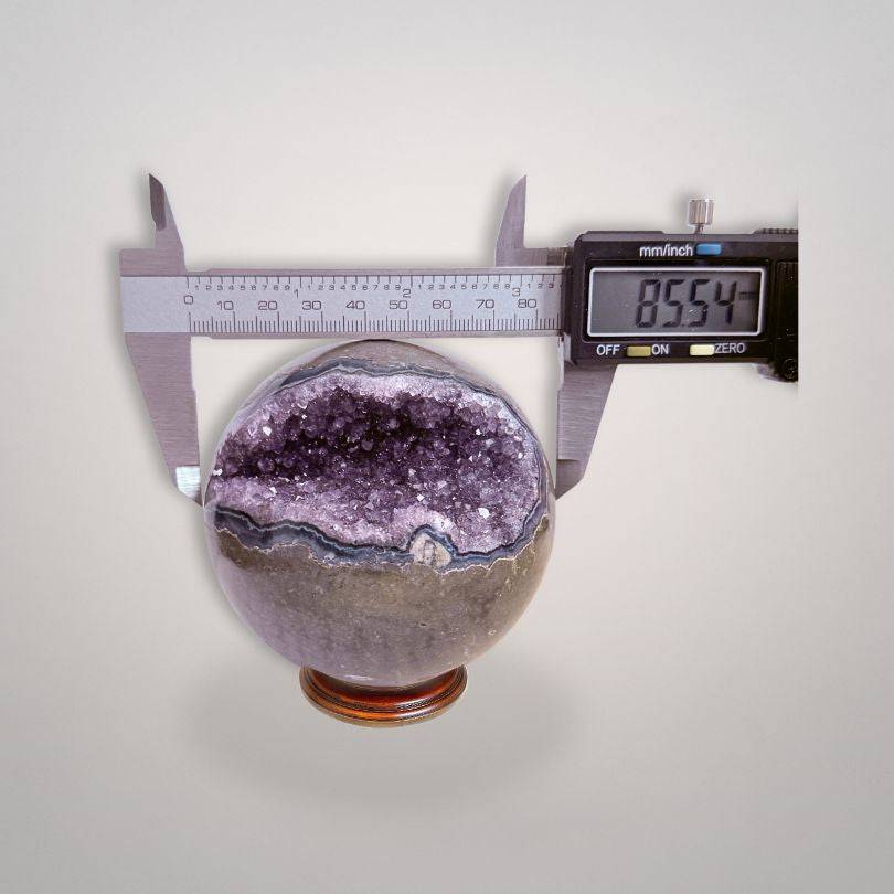 Amethyst Geode Sphere 761g from Brazil measured at 85.54mm, featuring sparkling druzy core for collectors and spiritual enthusiasts.