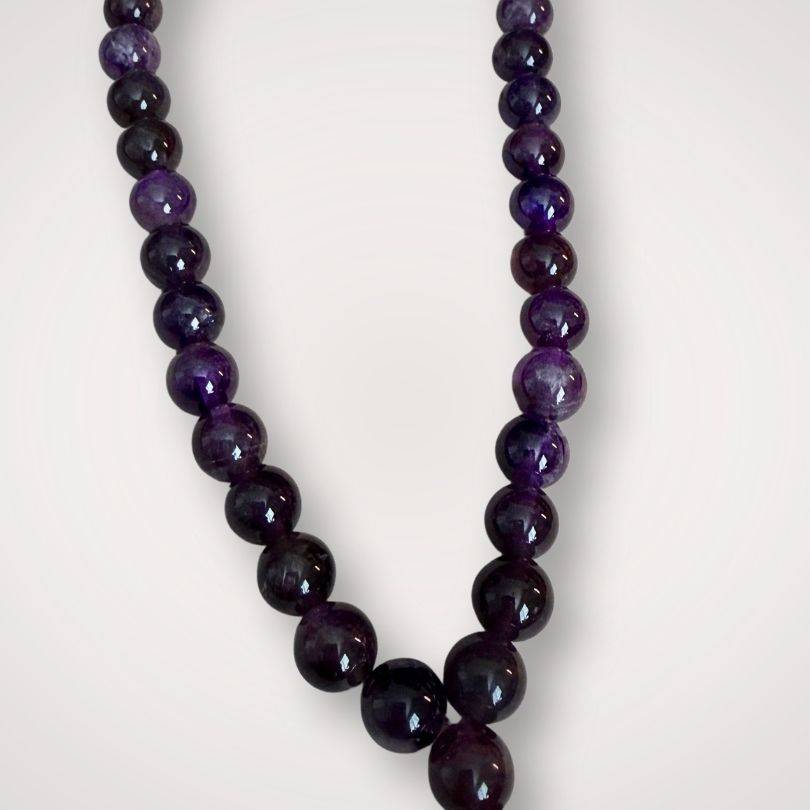Close-up of Amethyst Mala for calm meditation showing glossy purple beads, crafted for spiritual focus and ceremonial use in prayer routines.