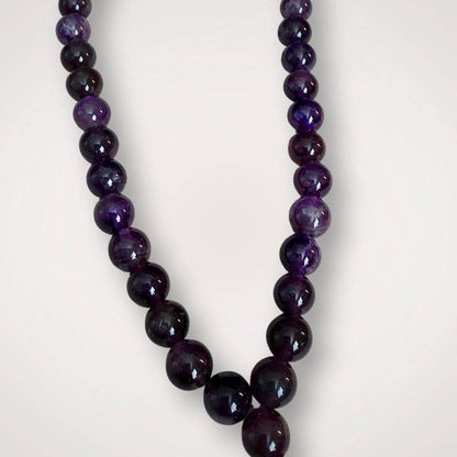 Close-up of Amethyst Mala for calm meditation showing glossy purple beads, crafted for spiritual focus and ceremonial use in prayer routines.
