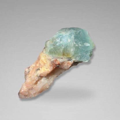 Brazil Gem Trio - Raw Aquamarine, Peach Moonstone & Pink Tourmaline specimen featuring a vibrant aquamarine crystal atop a peach and pink mineral base. Ideal for gemstone collectors and crystal enthusiasts.