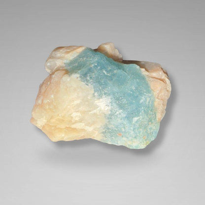 Brazil Gem Trio specimen featuring a smooth aquamarine surface blended with peach moonstone matrix. A beautiful raw gemstone for display or collection.