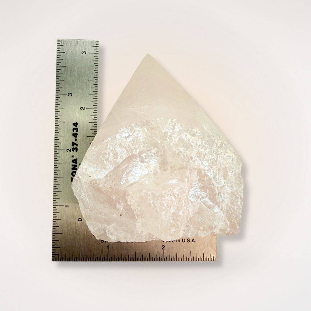 Aura Coated Quartz Point next to a ruler for scale, showing its size and polished top with natural sides for clarity and energy boosting.