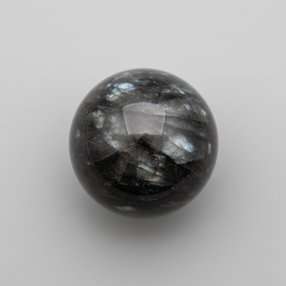 Soulful Black Moonstone Sphere with shimmering silver flashes, ideal for intuition and meditation in gemstone collectibles.