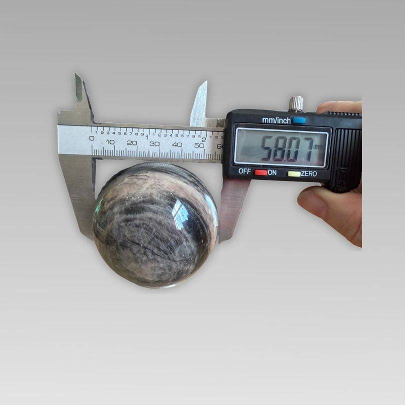 Soulful Black Moonstone Sphere measuring 58.07mm with digital caliper, ideal for intuition and meditation in crystal rock collectibles.