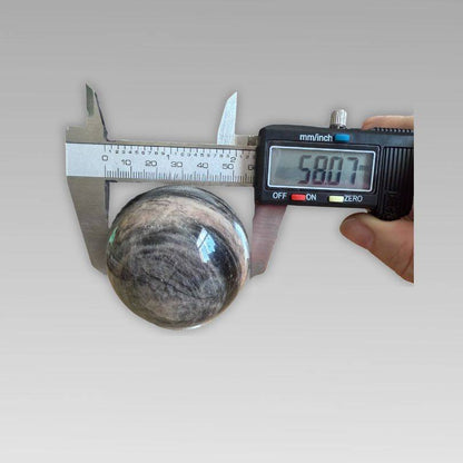 Soulful Black Moonstone Sphere measuring 58.07mm with digital caliper, ideal for intuition and meditation in crystal rock collectibles.