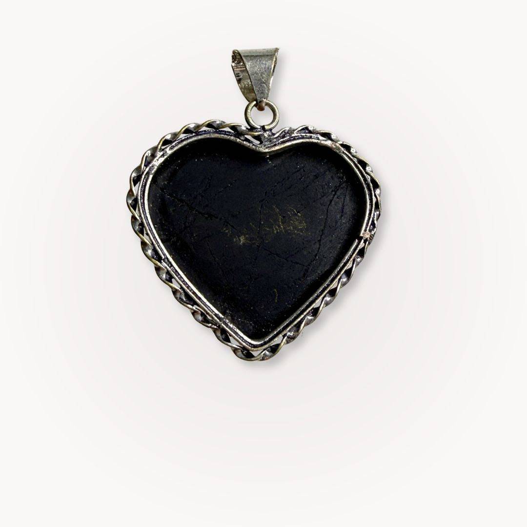 Back view of Black Tourmaline Heart Pendant with silver frame, emphasizing handcrafted details and crystal's protective properties.
