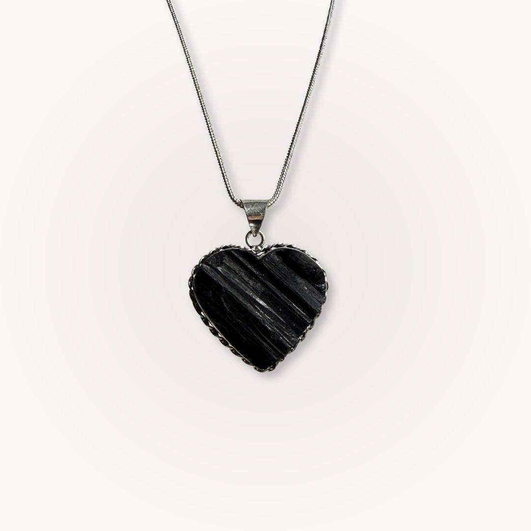 Black Tourmaline Heart Pendant on silver chain, ideal for protection and grounding. Features raw crystal texture in heart shape for spiritual balance.