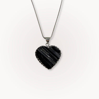 Black Tourmaline Heart Pendant on silver chain, ideal for protection and grounding. Features raw crystal texture in heart shape for spiritual balance.